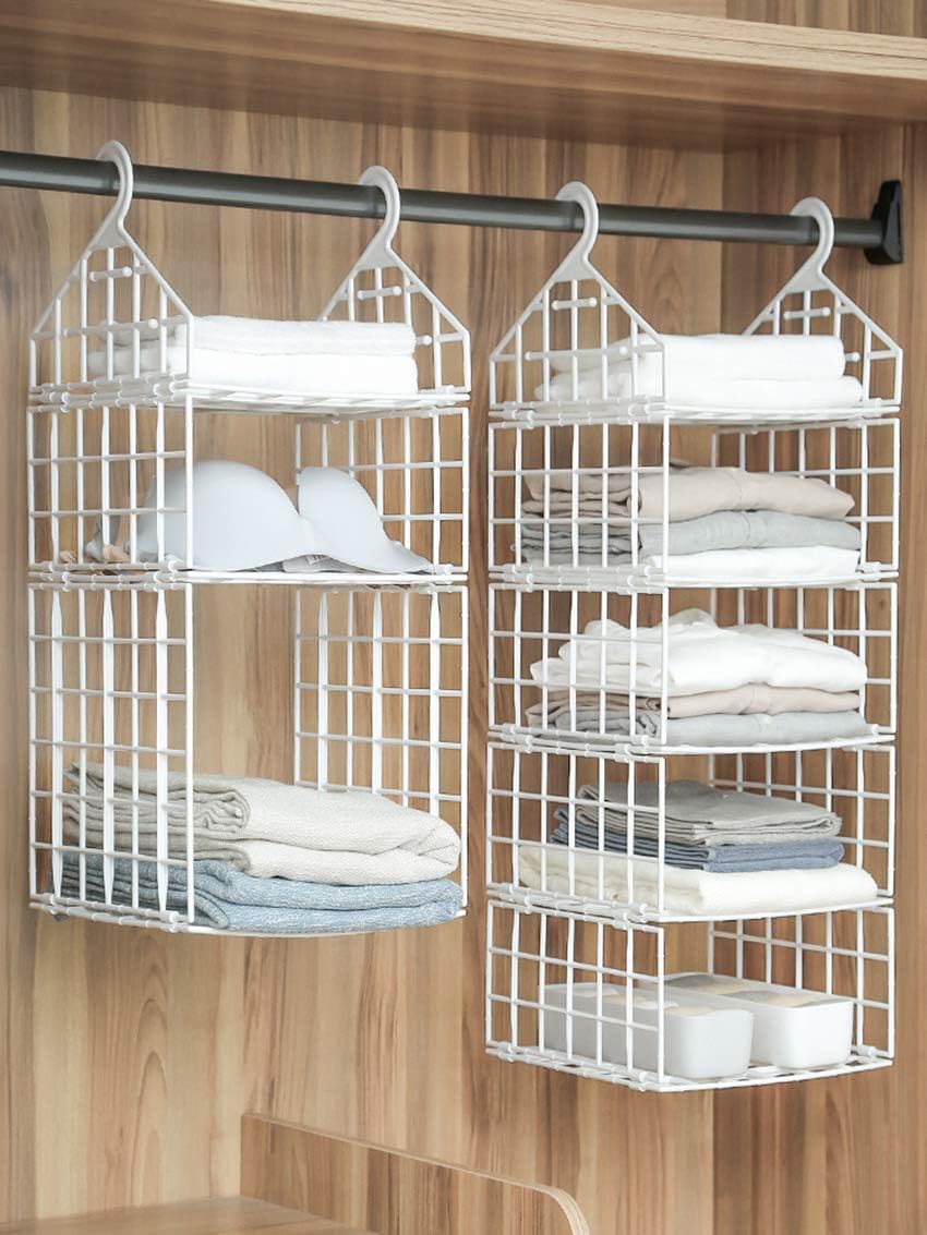 Image showing two Booluee hanging closet organizers side-by-side in a wooden closet, both filled with folded clothes, hats, and small storage boxes. The organizers are suspended from a metal closet rod.
