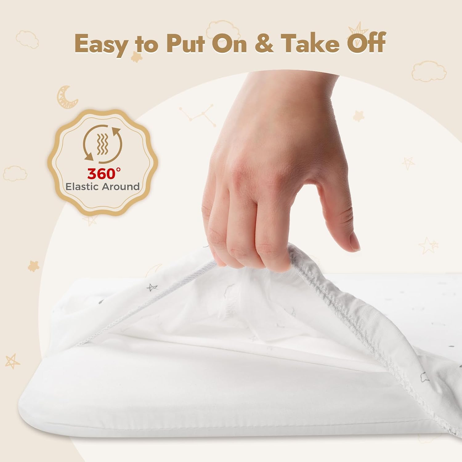 Hand pulling elastic bassinet sheet over a mattress corner