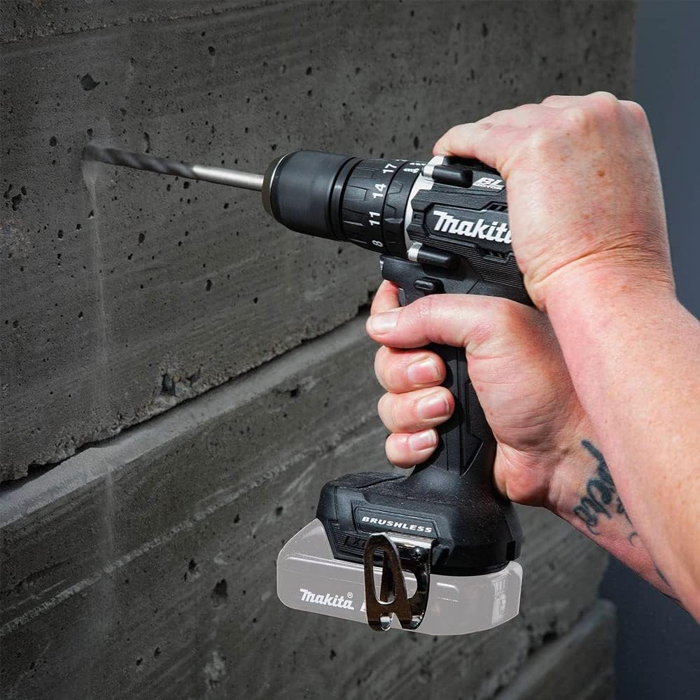 A person using the Makita DDF487ZB drill/driver to drill into a concrete or masonry surface.
