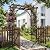 Outvita 7.1FT Wooden Garden Arbor with Gate, Weather-Resistant Garden Arch Trellis with Lattice Side, Outdoor Picket Fence Arbor for Climbing Plants, Yard & Wedding Decoration