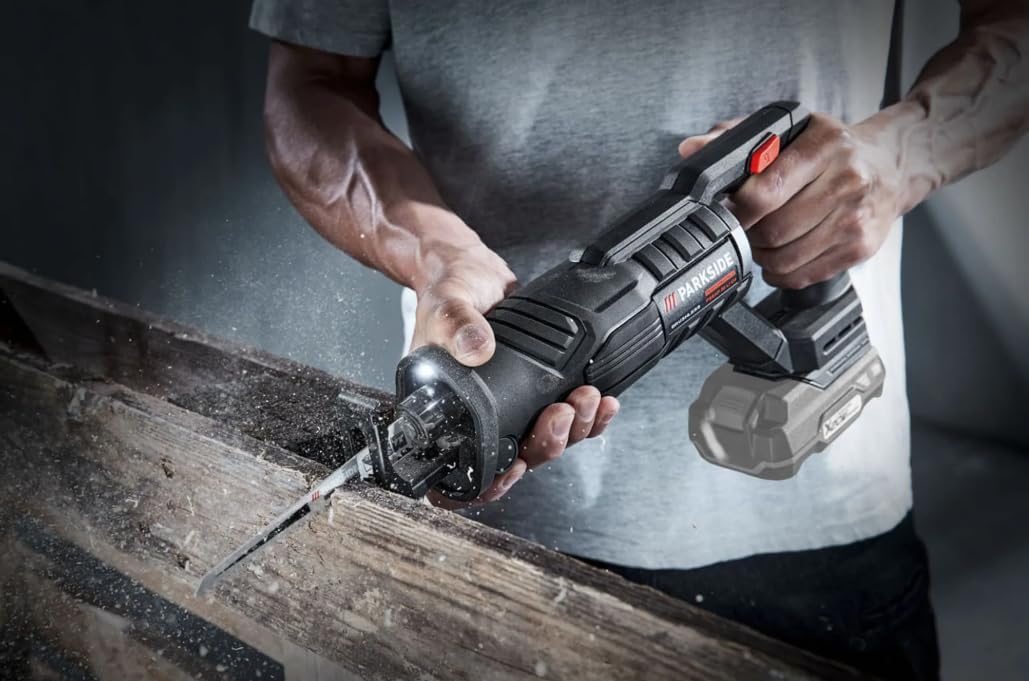 Man operating the Parkside Performance 2028 Reciprocating Saw to cut wood