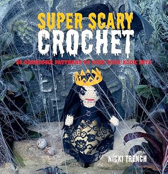 A cover of Super Scary Crochet by Nicki Trench. There is a little crocheted woman standing in front of what looks like spider webs.