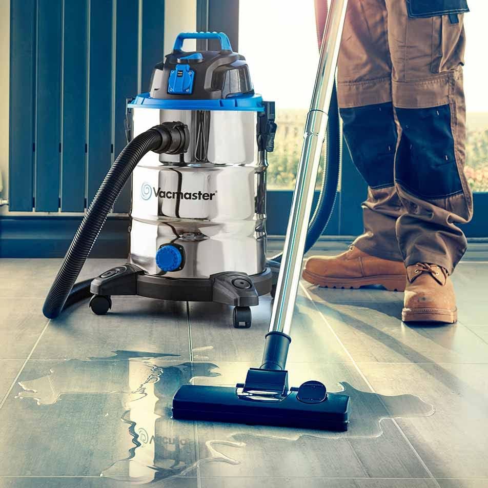 Vacmaster VQ1530SFDC vacuum cleaning a wet spill on a tiled floor