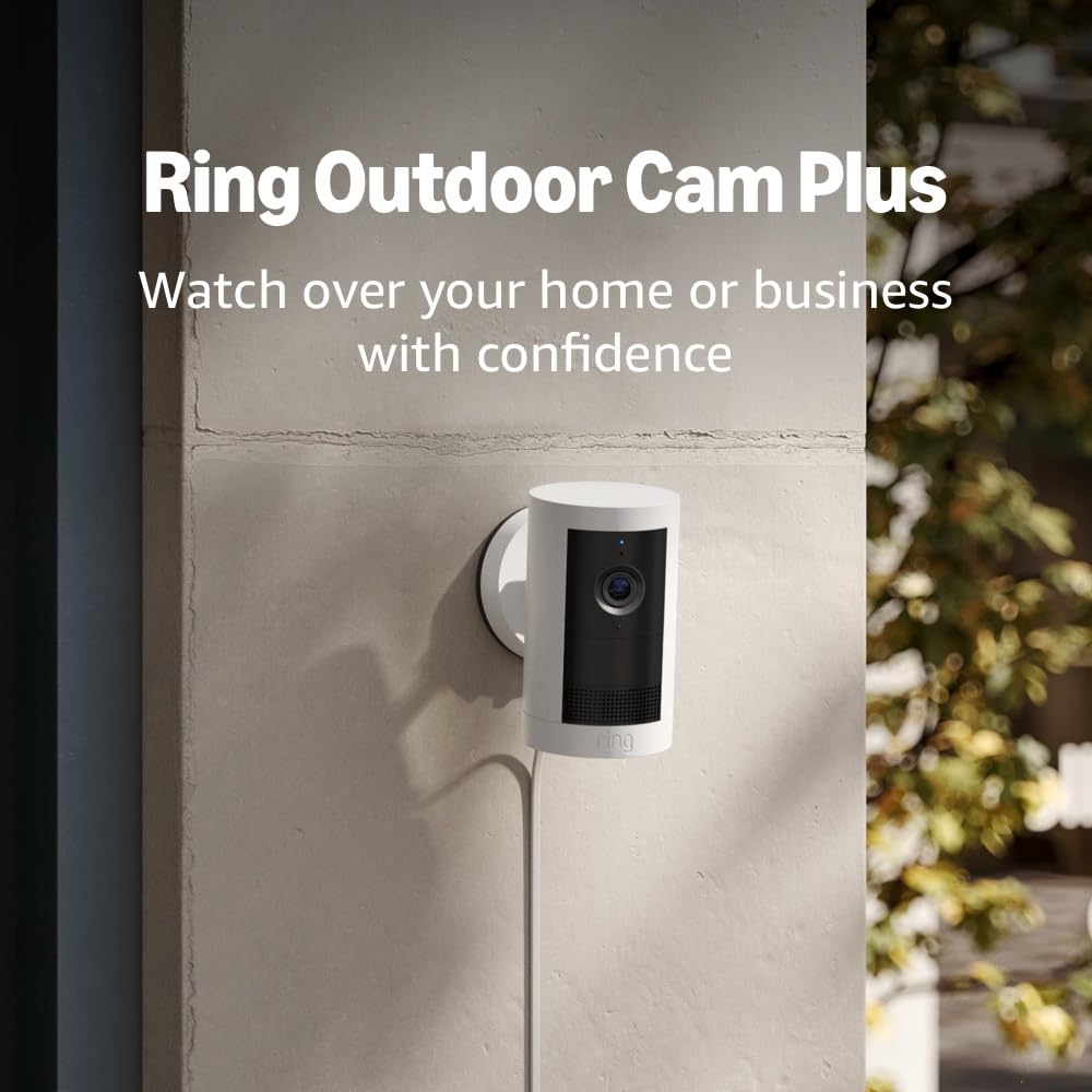 Ring Outdoor Cam Plus mounted on an exterior wall, showing its compact design and plug-in cable.