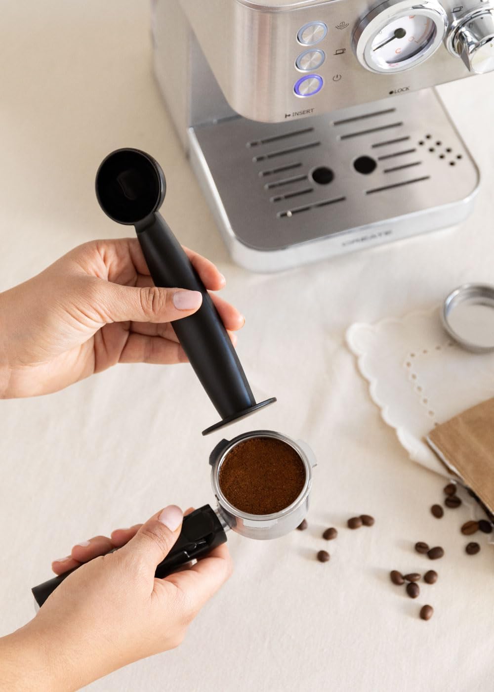 Hand tamping ground coffee into a portafilter
