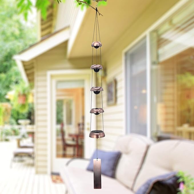 The Red Copper Wind Chimes with 5 Bells and Feng Shui Wind Chime for Home Yard Outdoor Decoration are both stylish and functional options for adding a touch of elegance to your outdoor space. The red copper finish gives a chic and timeless look while the multiple bells create a harmonious and melodious sound when the wind passes through them. These wind chimes can be a great choice for someone who loves peace and enjoys the ambiance of wind chimes in their surroundings. Description by ChatGPT.