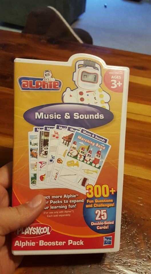 Playskool Alphie robot interacting with a music card