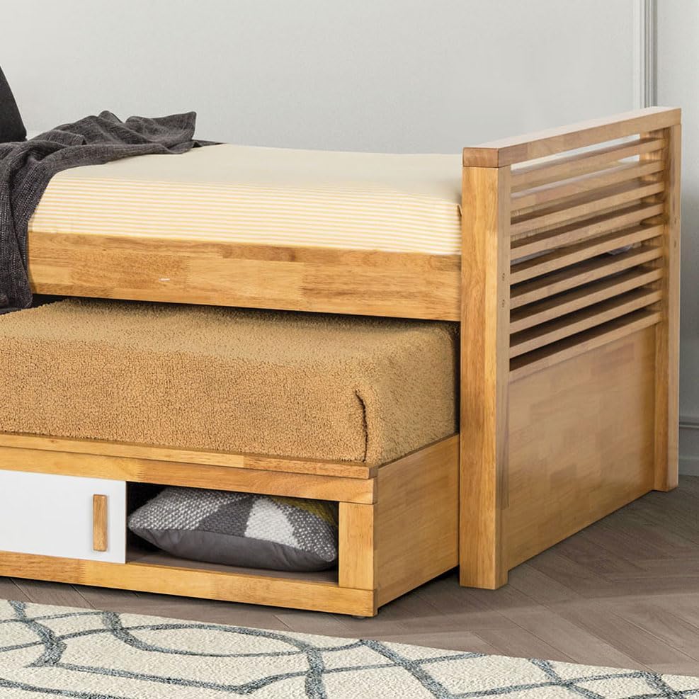 Sliding storage compartment under the trundle