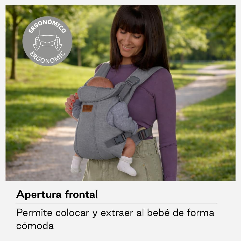 Parent carrying baby in the Jané Dual Ergonomic Baby Carrier, with the baby facing the adult.