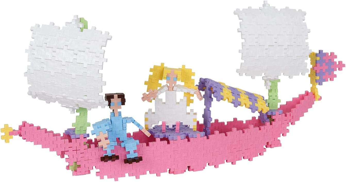 Assembled Plus-Plus boat with pink hull and white sails, carrying two figures.