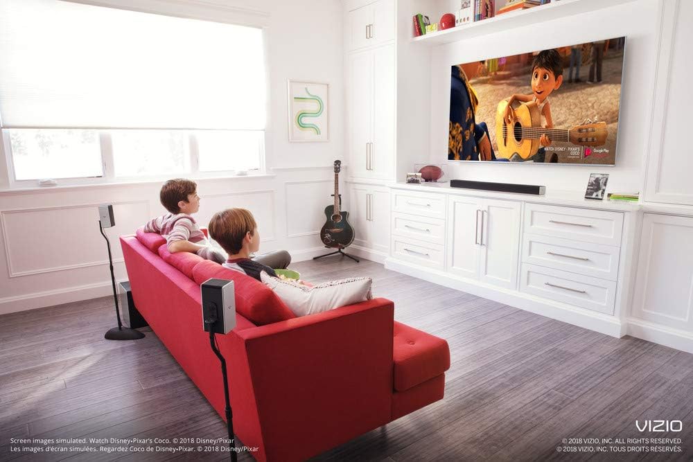 VIZIO sound bar system set up in a living room with a TV and couch.
