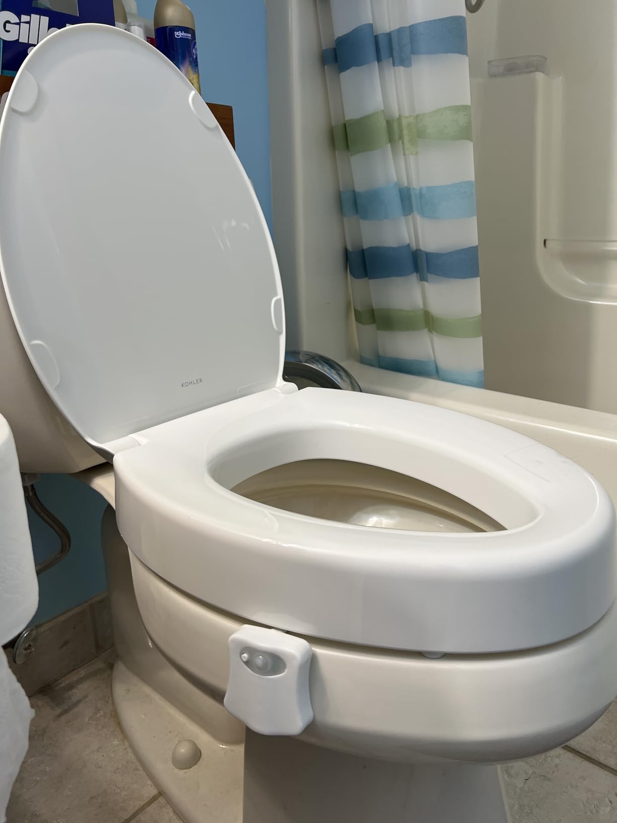 KOHLER Hyten Elevated Toilet Seat on white toilet