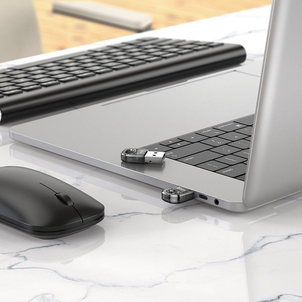 Hoco UA28 USB Bluetooth Adapter connected to a laptop with a wireless mouse and keyboard
