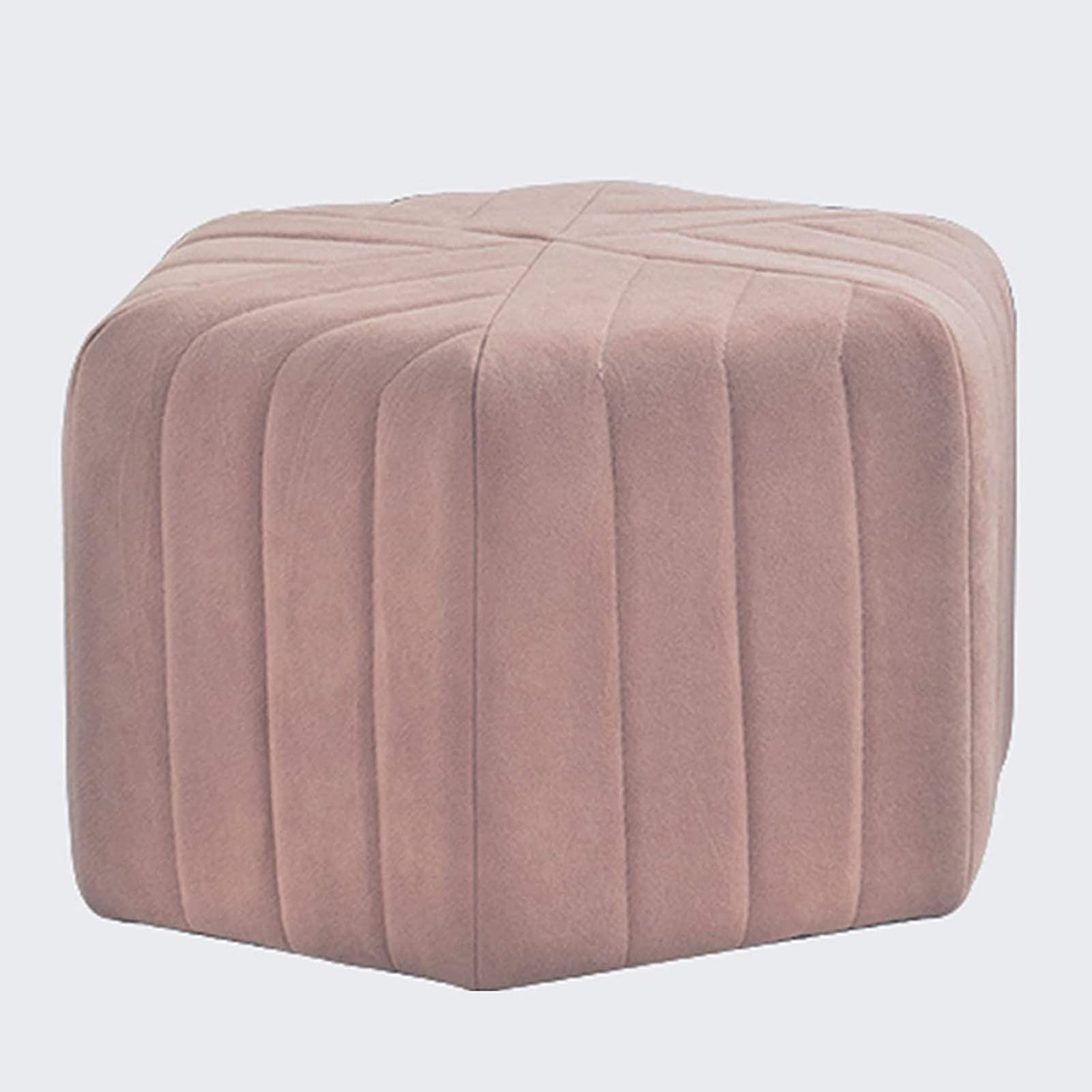 Repose-pieds de salon rose en velours pour créer un coin lecture chaleureux