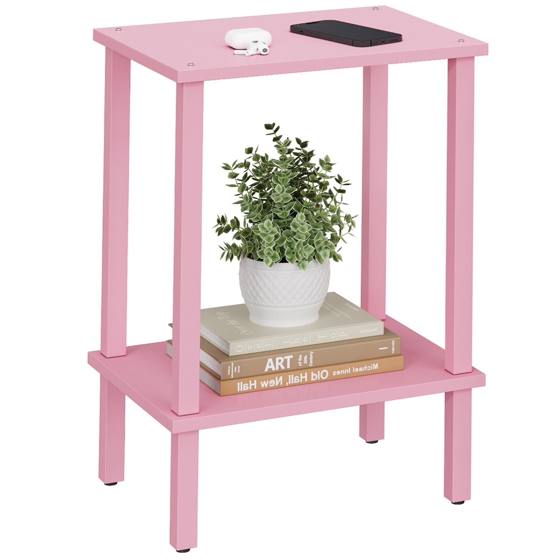 Pink end table with a lamp and coffee cup next to a sofa in a living room.