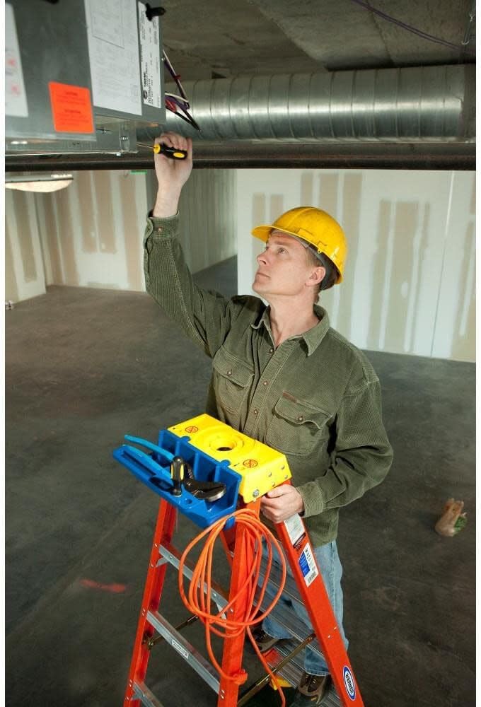 Person using Werner stepladder for overhead work