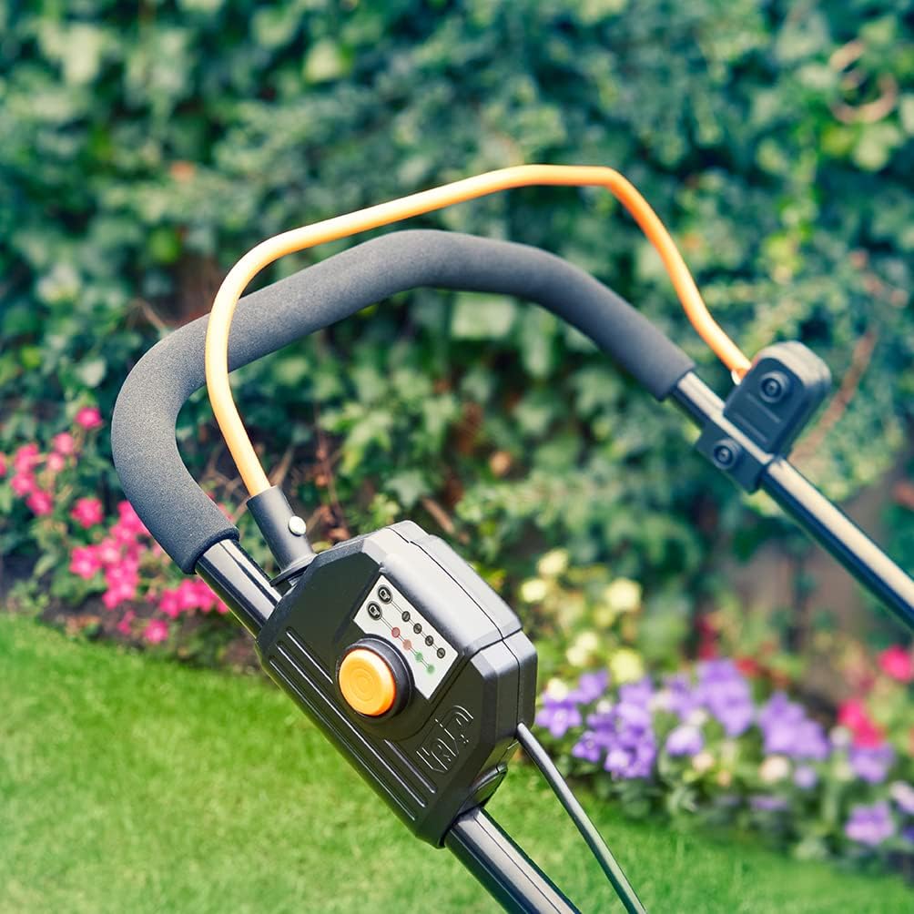 Hand inserting a 24V battery into the LawnMaster lawn mower's battery compartment