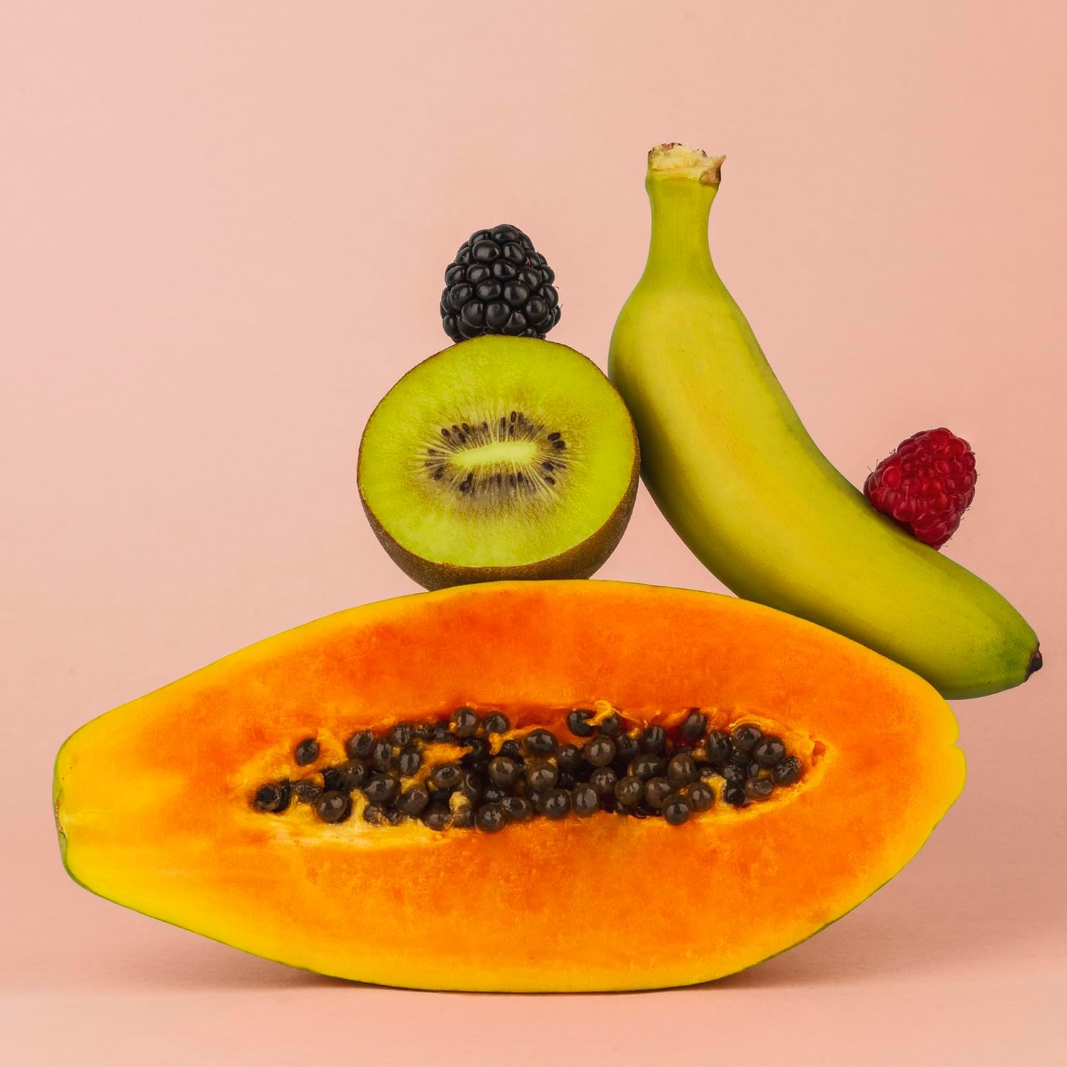Assortment of fresh fruits including papaya, kiwi, banana, blackberries, and raspberries, ready for blending.