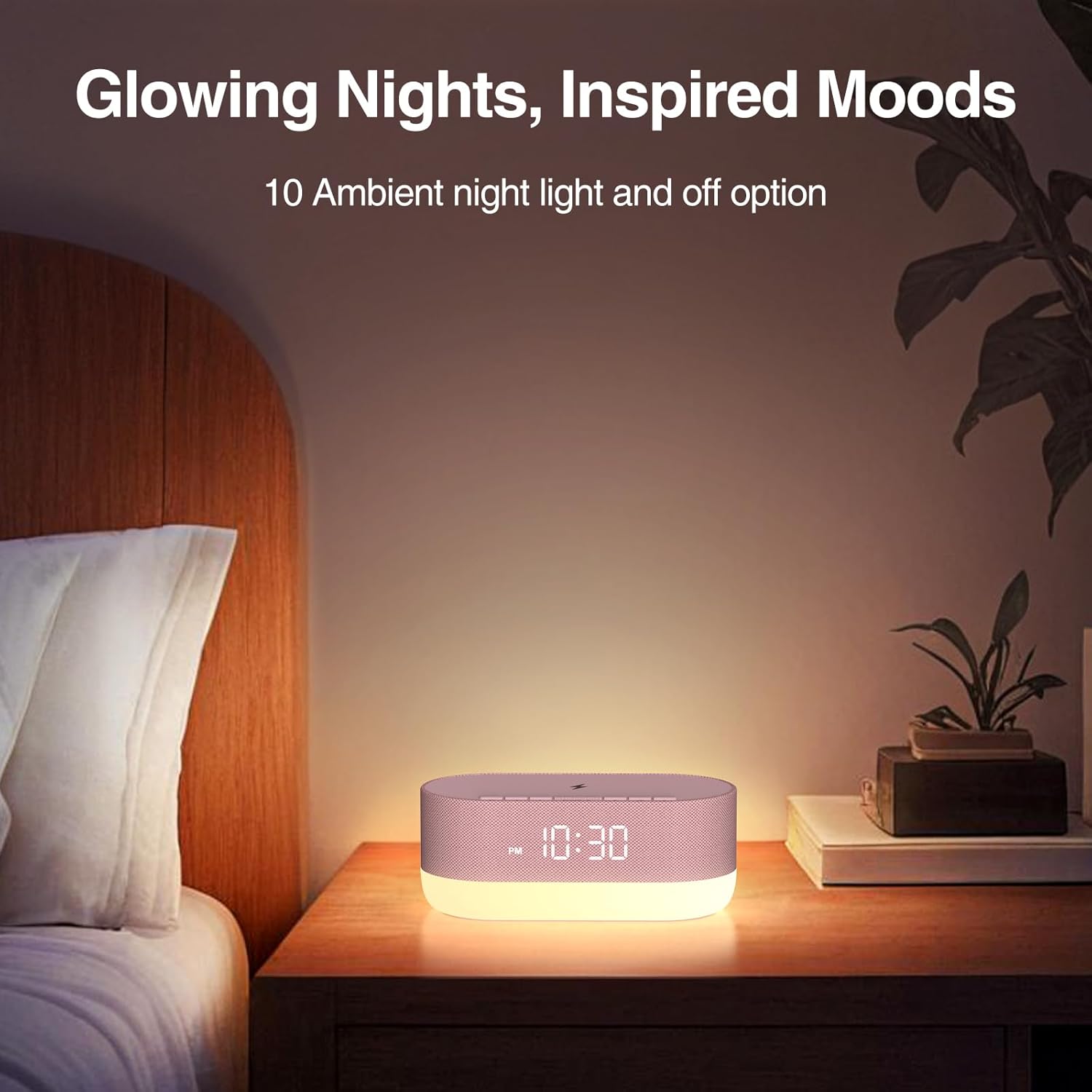 HOUSBAY Sound Machine acting as a night light on a bedside table in a dimly lit room.