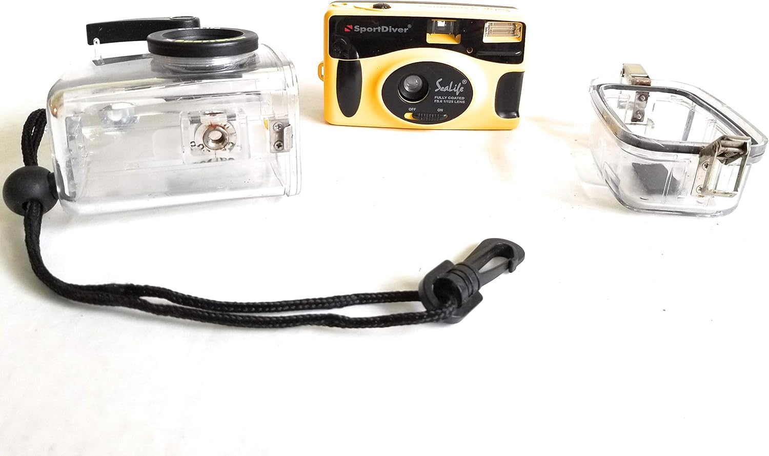 Disassembled SeaLife SportDiver II camera showing the inner camera, clear housing, and housing back.