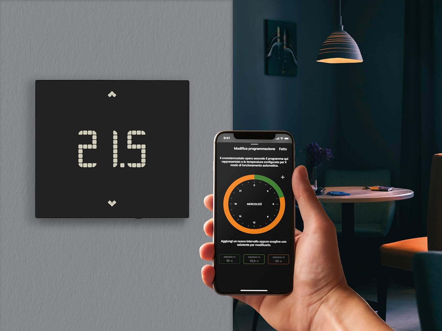 Vimar 02912.G Wi-Fi Thermostat next to a person using the Vimar View app on a smartphone.