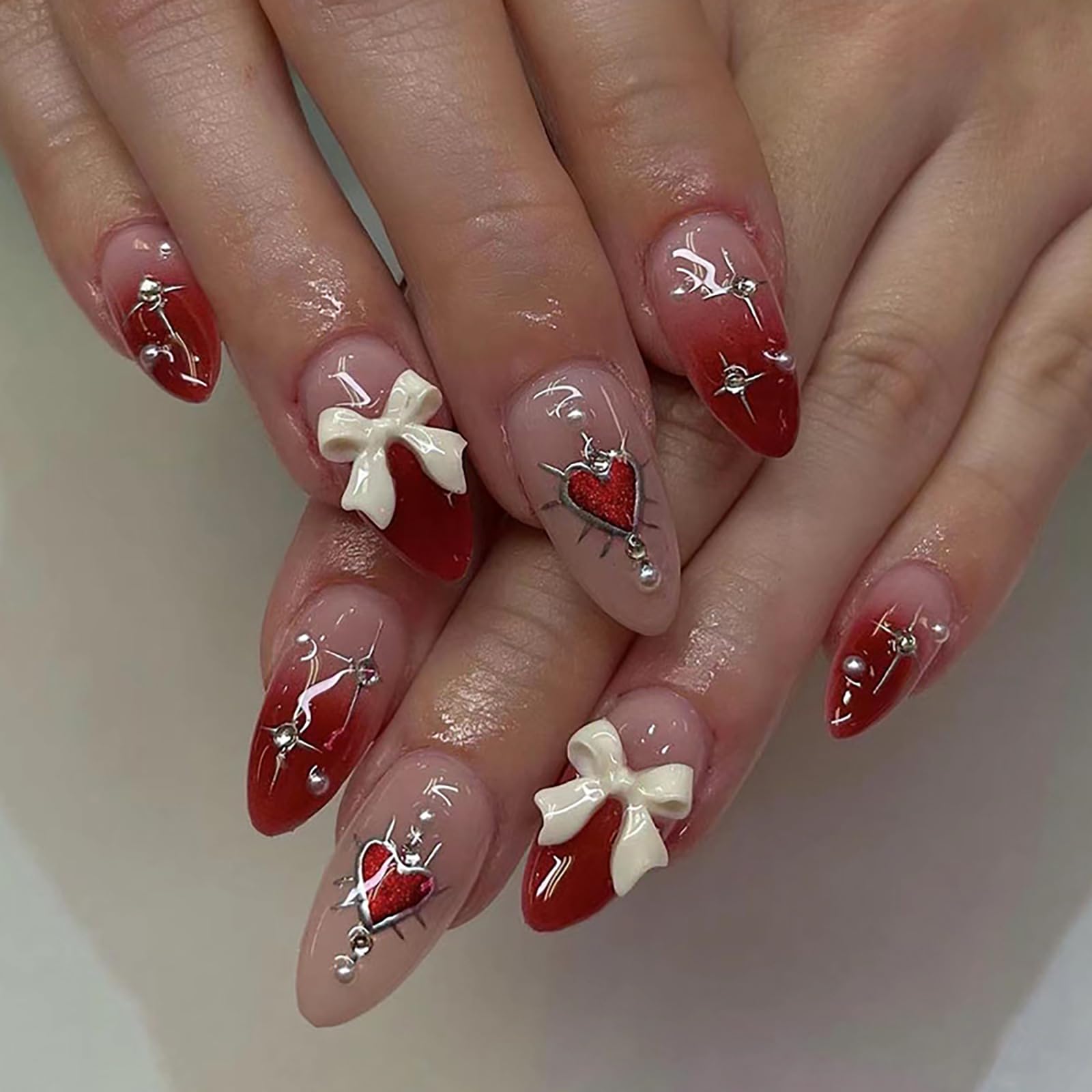 Photo 1 of Press on Nails Medium Almond Fake Nails Red Gradient Full Cover Bow Charm False Nails with Sliver Heart Designs Glossy Glue on Nails Cute Acrylic Artificial Nails for Women Girls 24Pcs