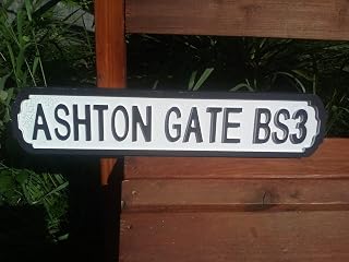 ASHTON GATE BS3 Retro style BRISTOL CITY football sign with a crackle finish. Makes a great gift. Size 52 x 11 cm. Comes with a hanging hook.