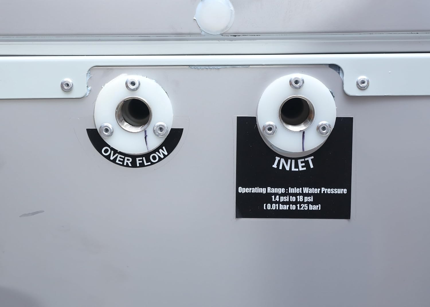 Close-up of water inlet and overflow connections on the back of the Blue Star PC3060SS water cooler.