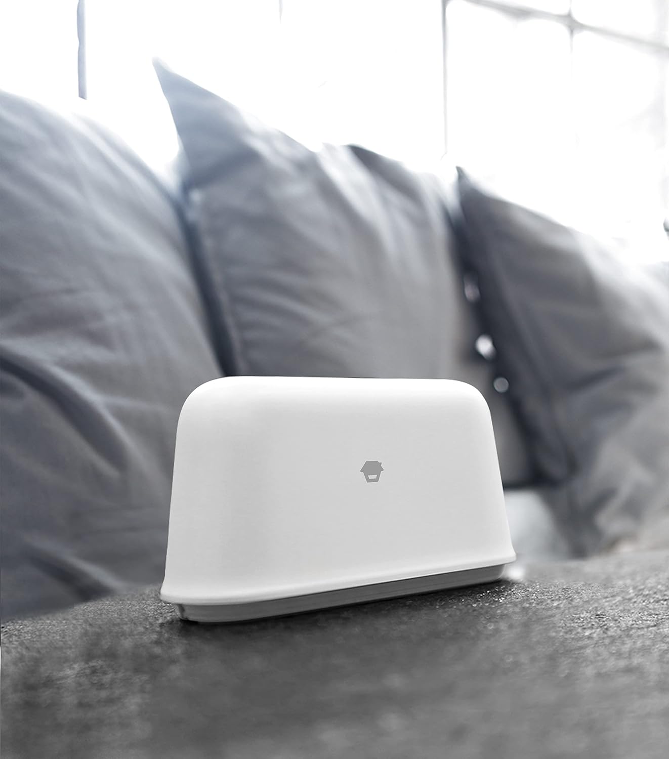Chuango Smart WiFi Alarm Hub placed on a dark surface in a home setting.