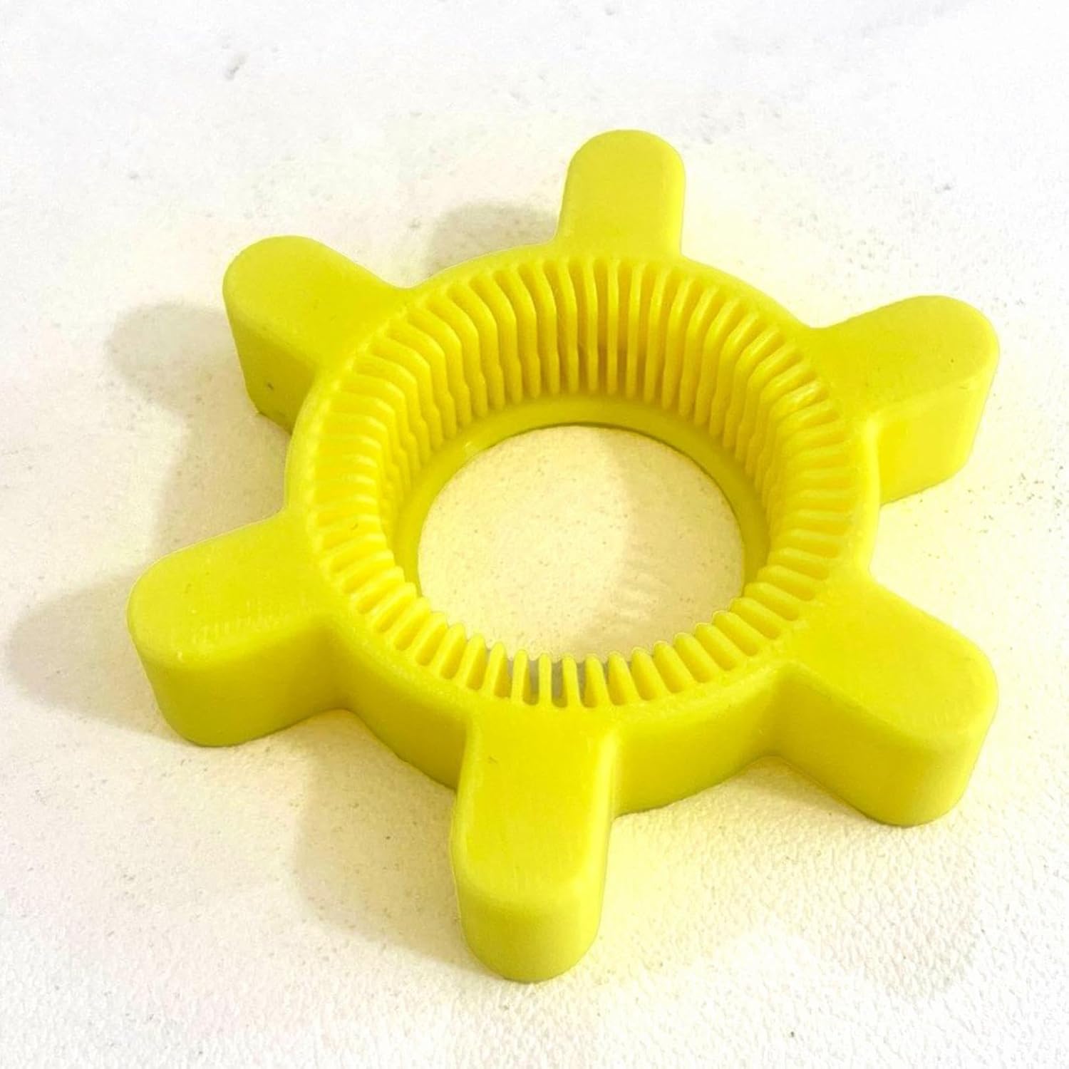 Single yellow silicone bottle opener, top view.
