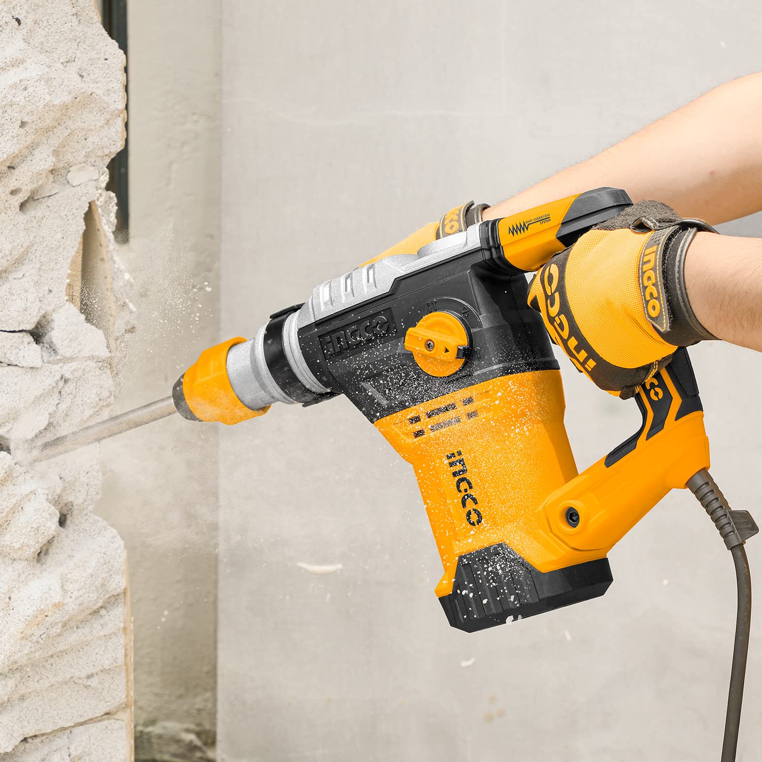 Person using the rotary hammer for chiseling a concrete wall