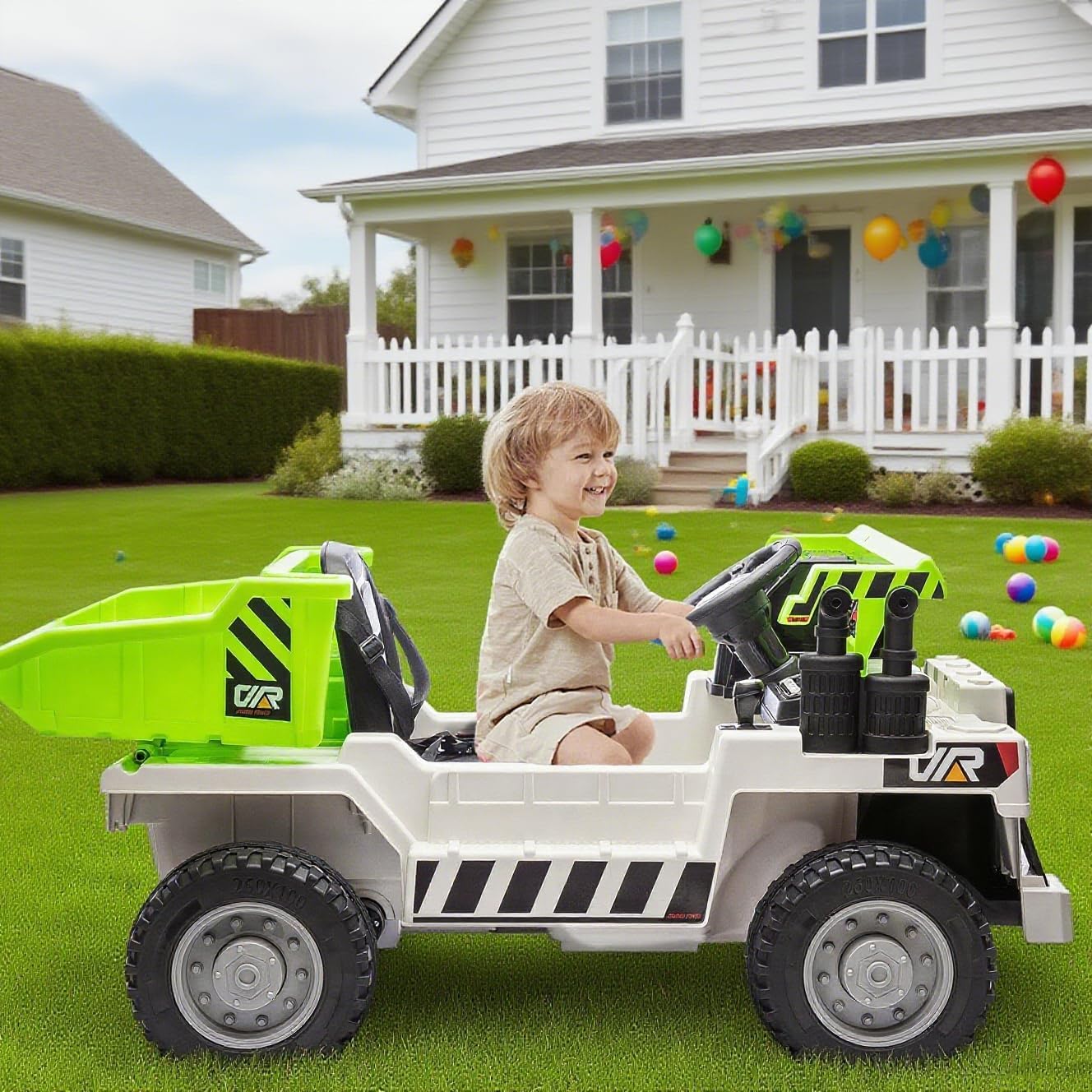 Hetoy 12V 4WD Kids Electric Ride On Dump Truck in white-green, parked on a lawn in front of a house.