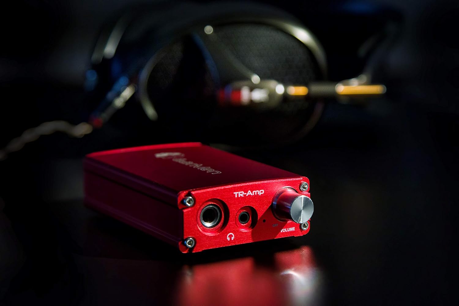 EarMen TR-Amp with headphones in the background
