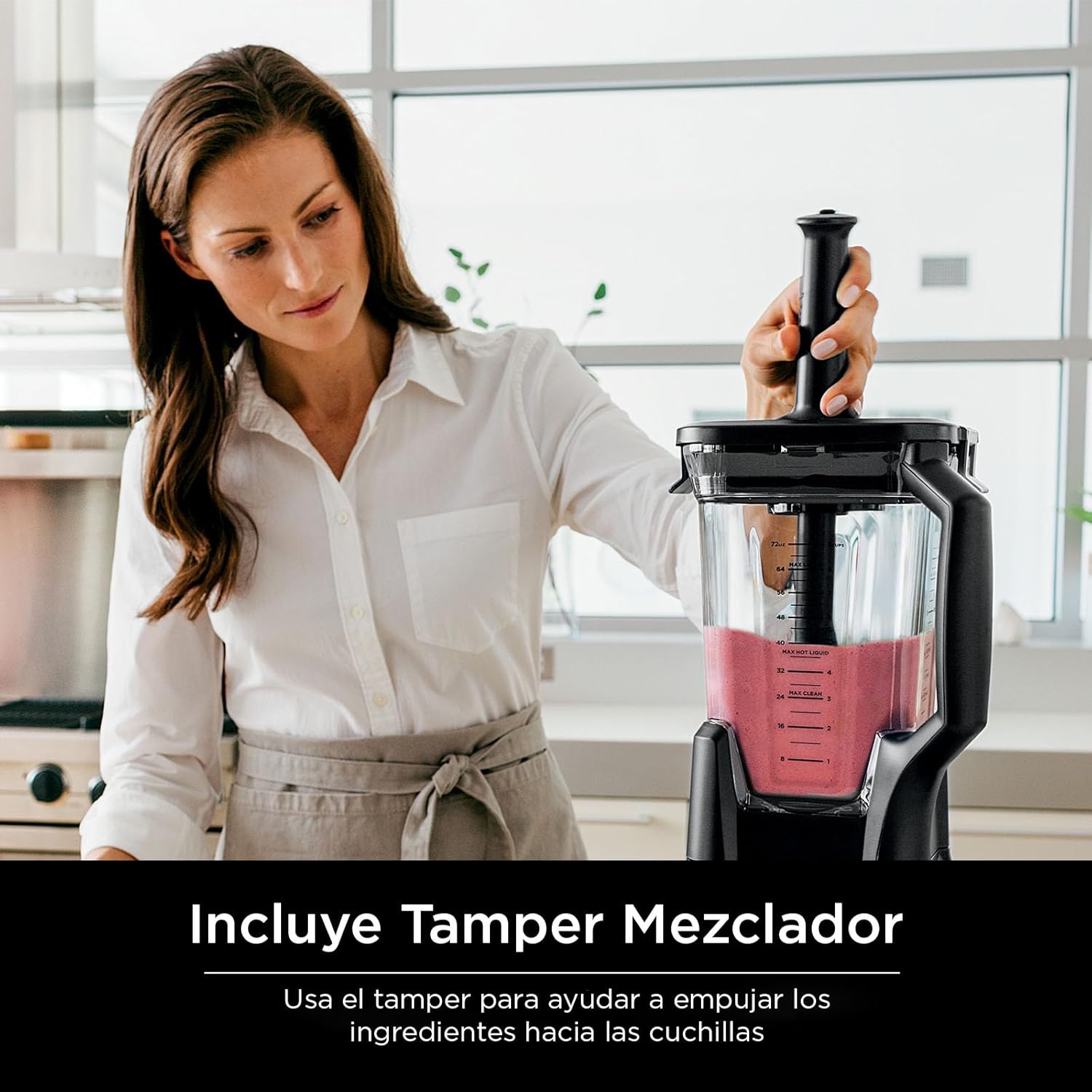 Woman using tamper with Ninja CT800 blender