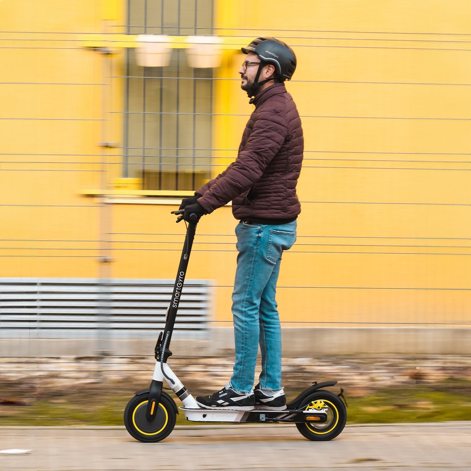 Person riding smartGyro Z-One 2 Electric Scooter on a paved path.