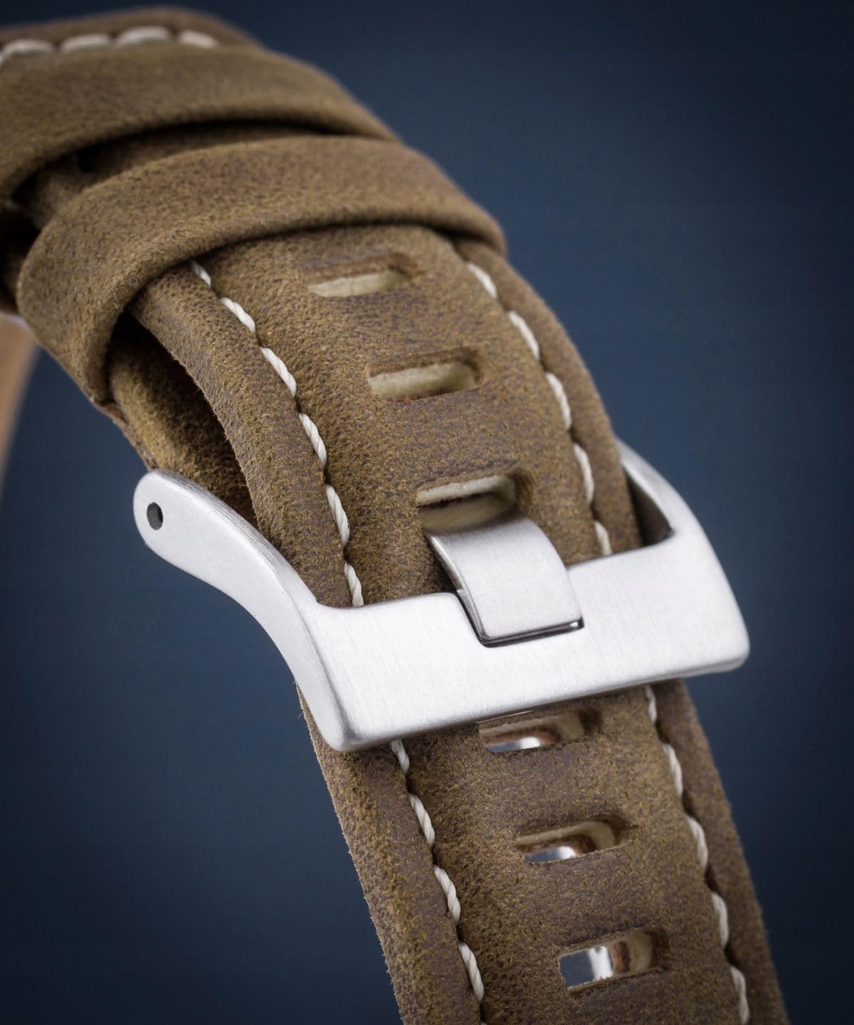 Close-up of the green leather watch strap and buckle