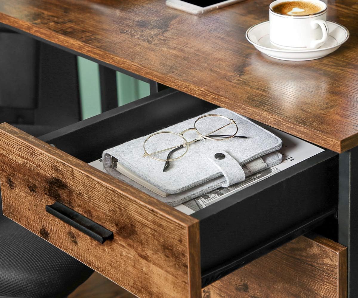 Close-up of the desk's drawer, open and containing a notebook and glasses.