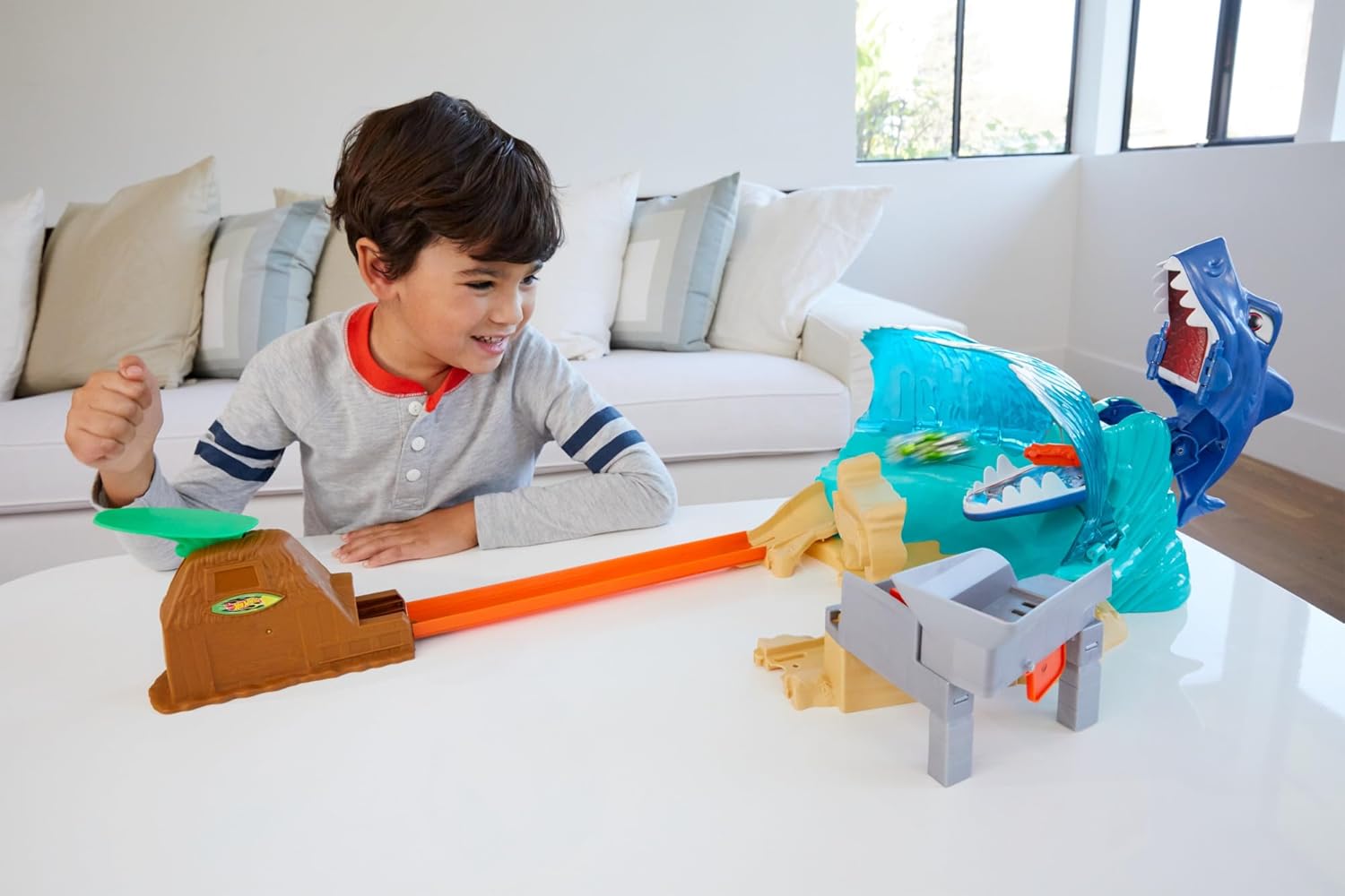 Child setting up the Hot Wheels Shark Beach Battle playset
