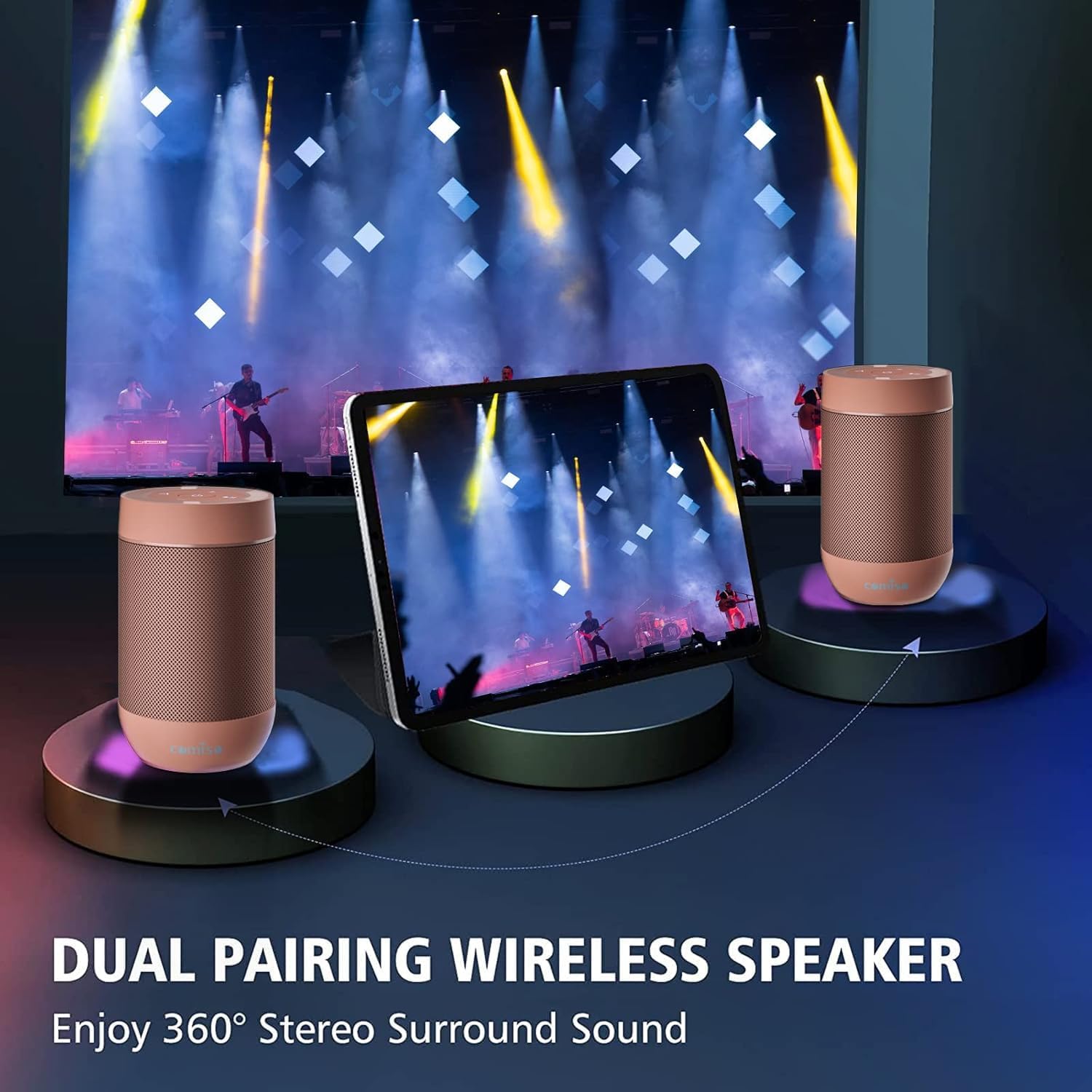 Two Comiso X26M speakers paired together, with a tablet displaying music in the background.