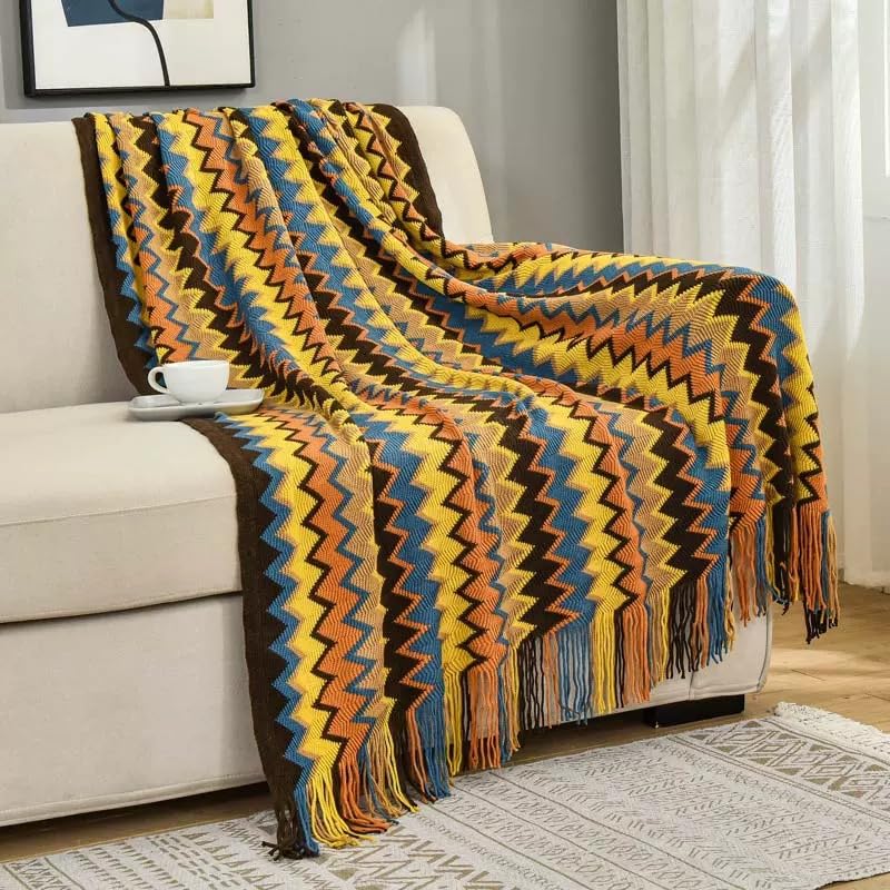 Jeté de canapé tissé d'exception avec pompons pour décoration raffinée