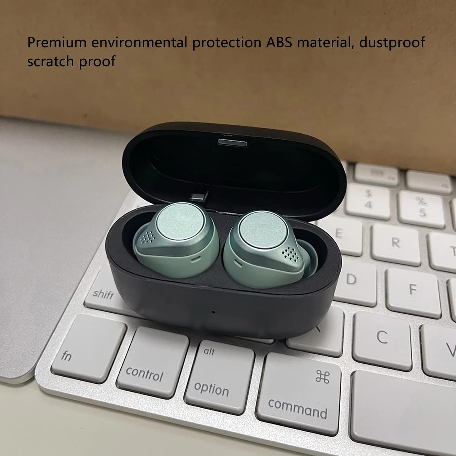 Jabra Elite 75t earbuds placed inside the Qcwwy charging case on a keyboard