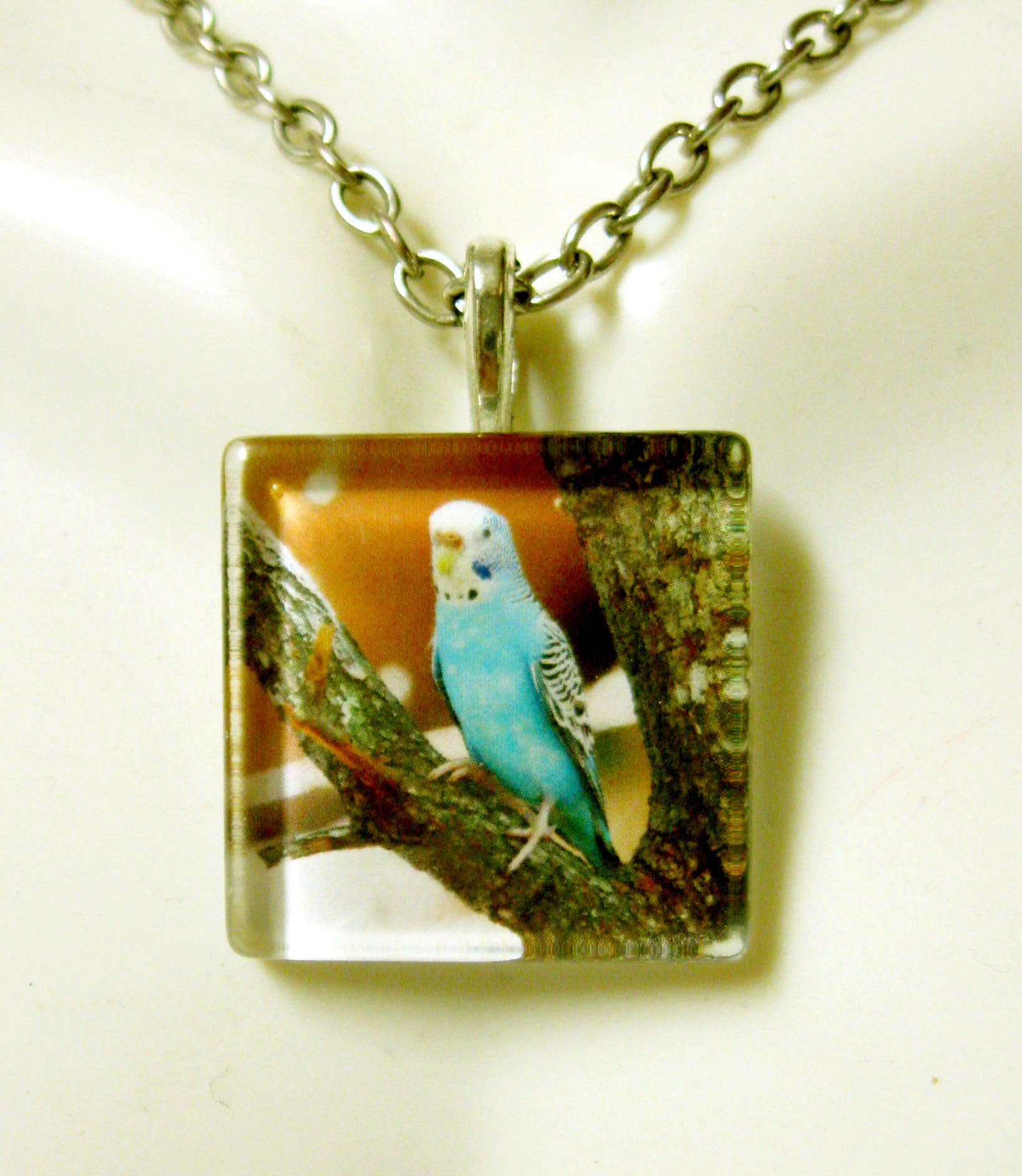 Blue parakeet on a tree branch glass pendant and chain - BGP01-073