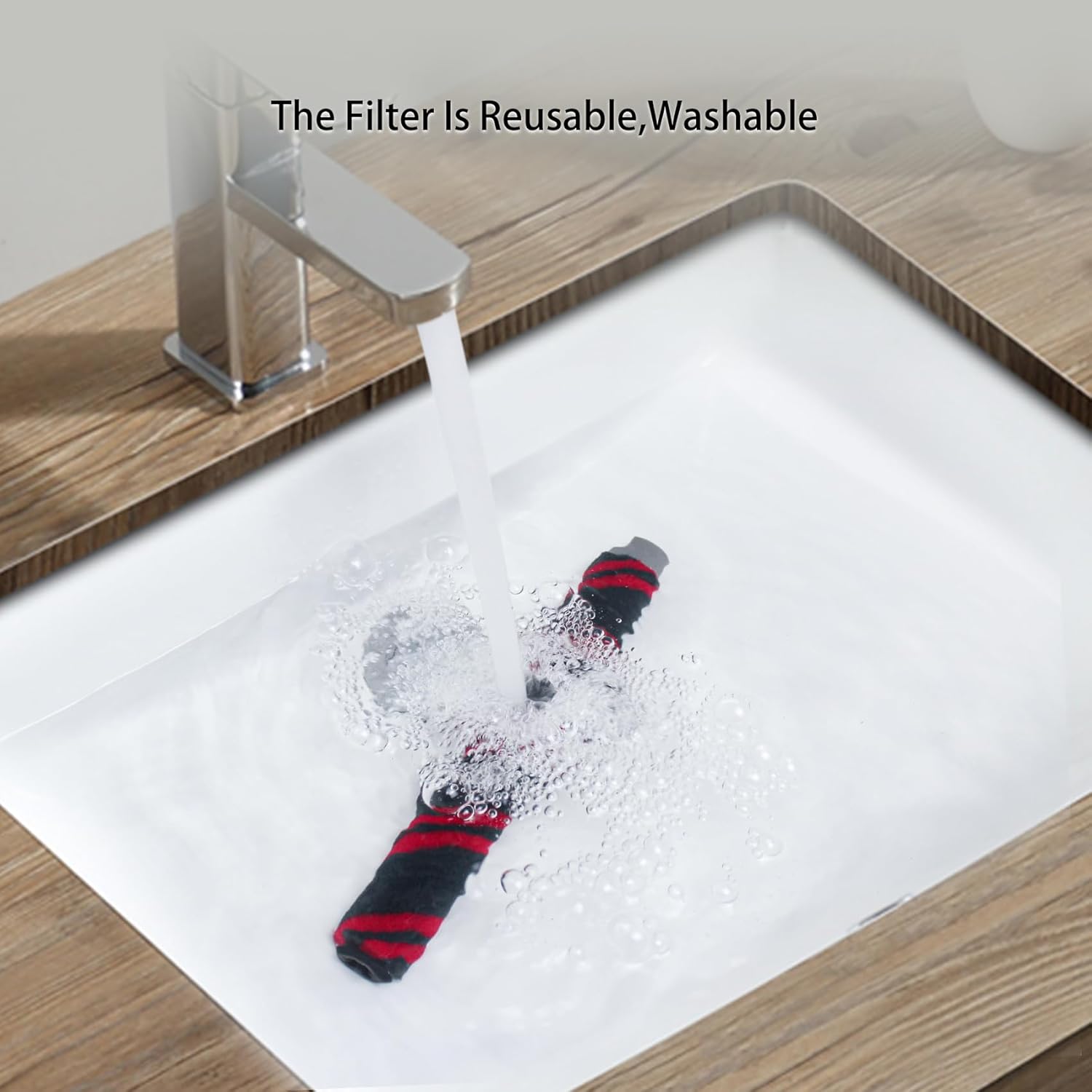 Brush roller being washed under running water in a sink