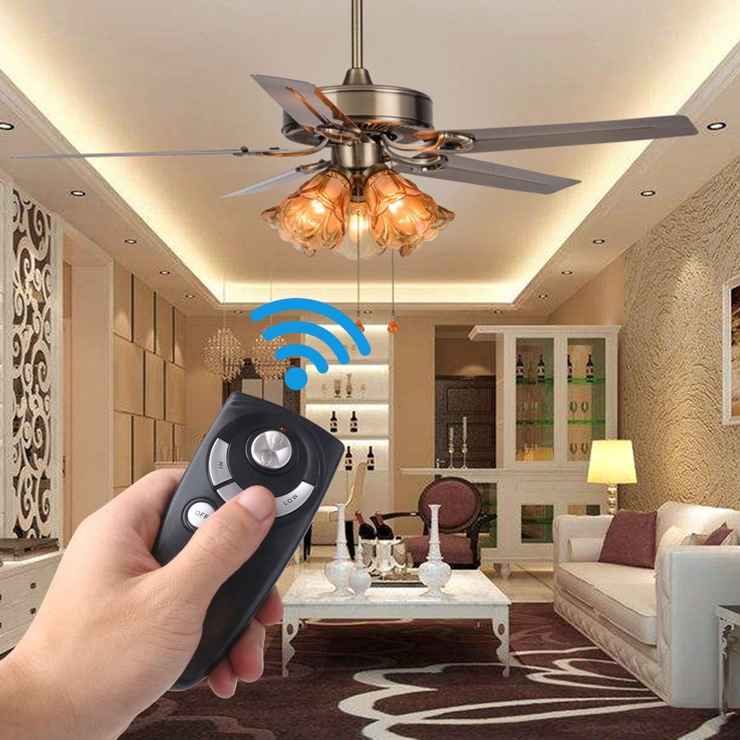 Hand holding remote control, operating a ceiling fan with light