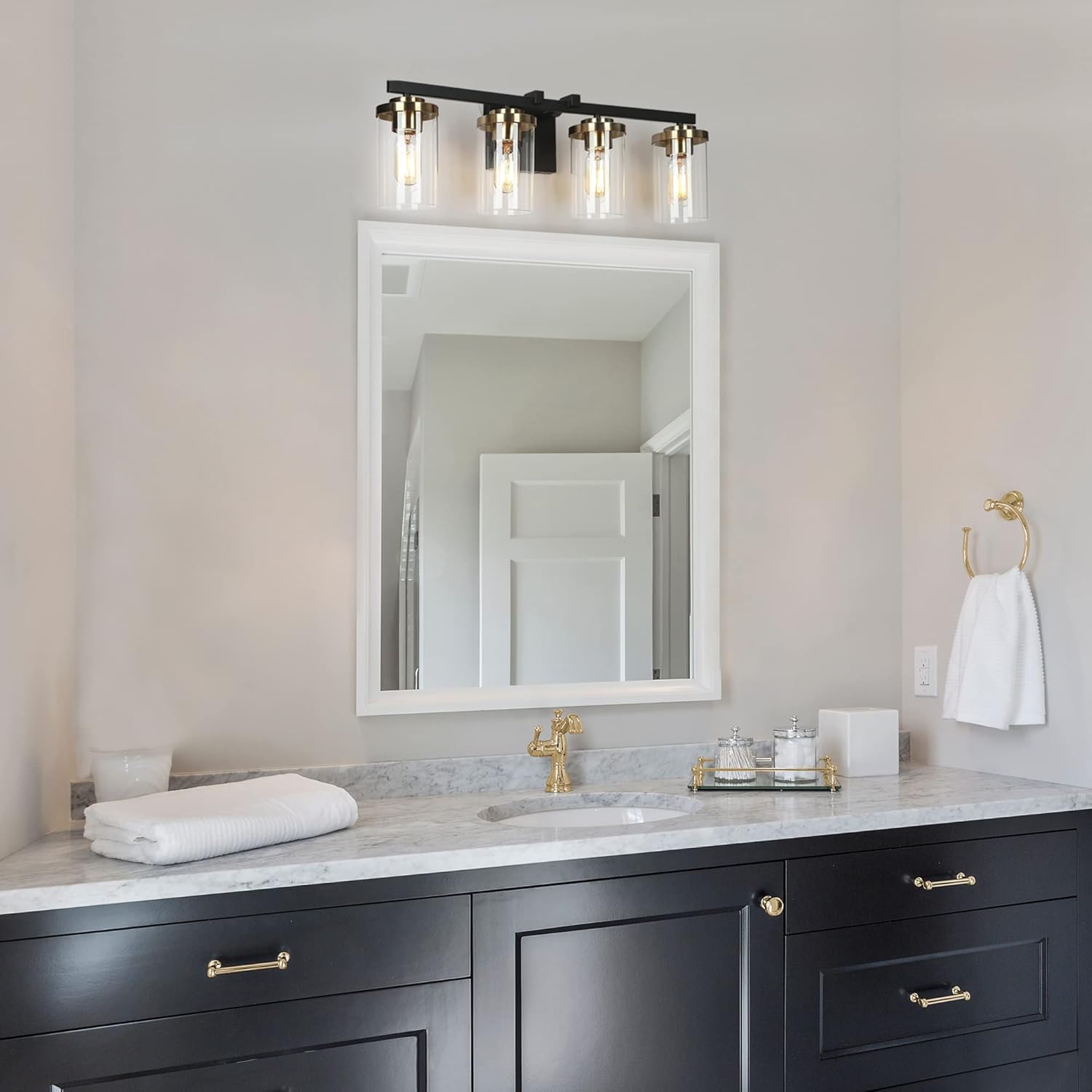 ZEVNI Black Vanity Light installed above a rectangular mirror in a bathroom with a white framed mirror