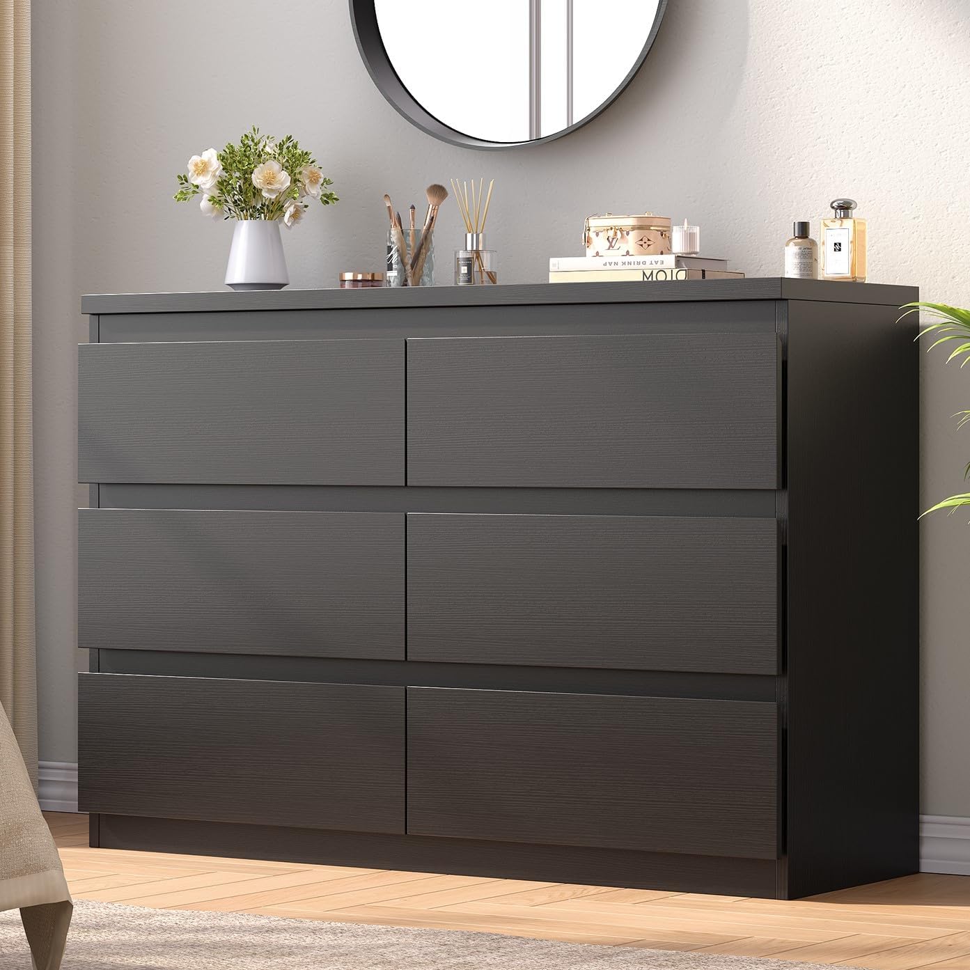Assembled Jocoevol 6-Drawer Dresser in black finish, featuring six spacious drawers and a flat top surface, placed in a modern bedroom setting.