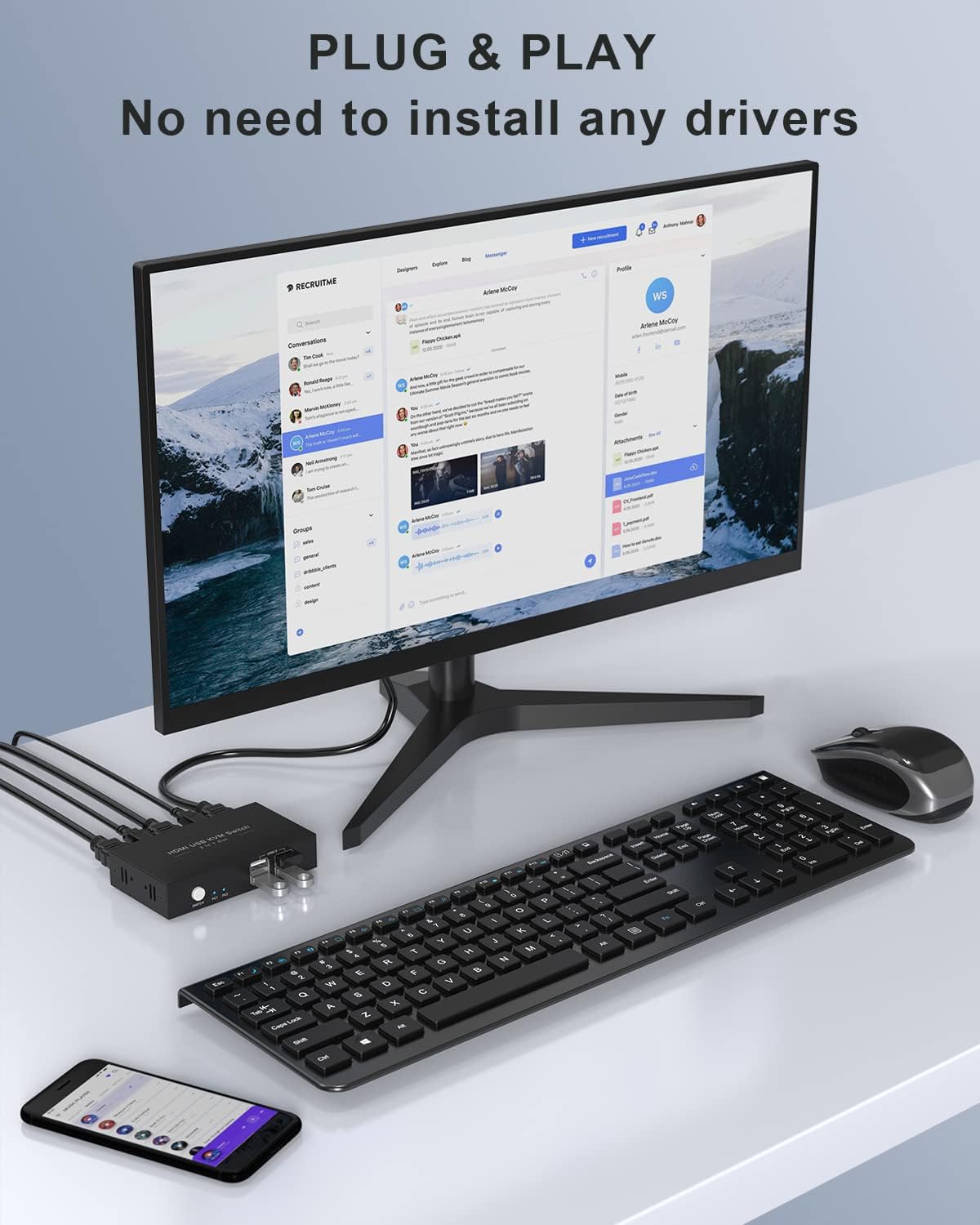 A desk setup showing the KVM switch connected to a monitor, keyboard, and mouse, emphasizing its plug-and-play functionality without requiring drivers.