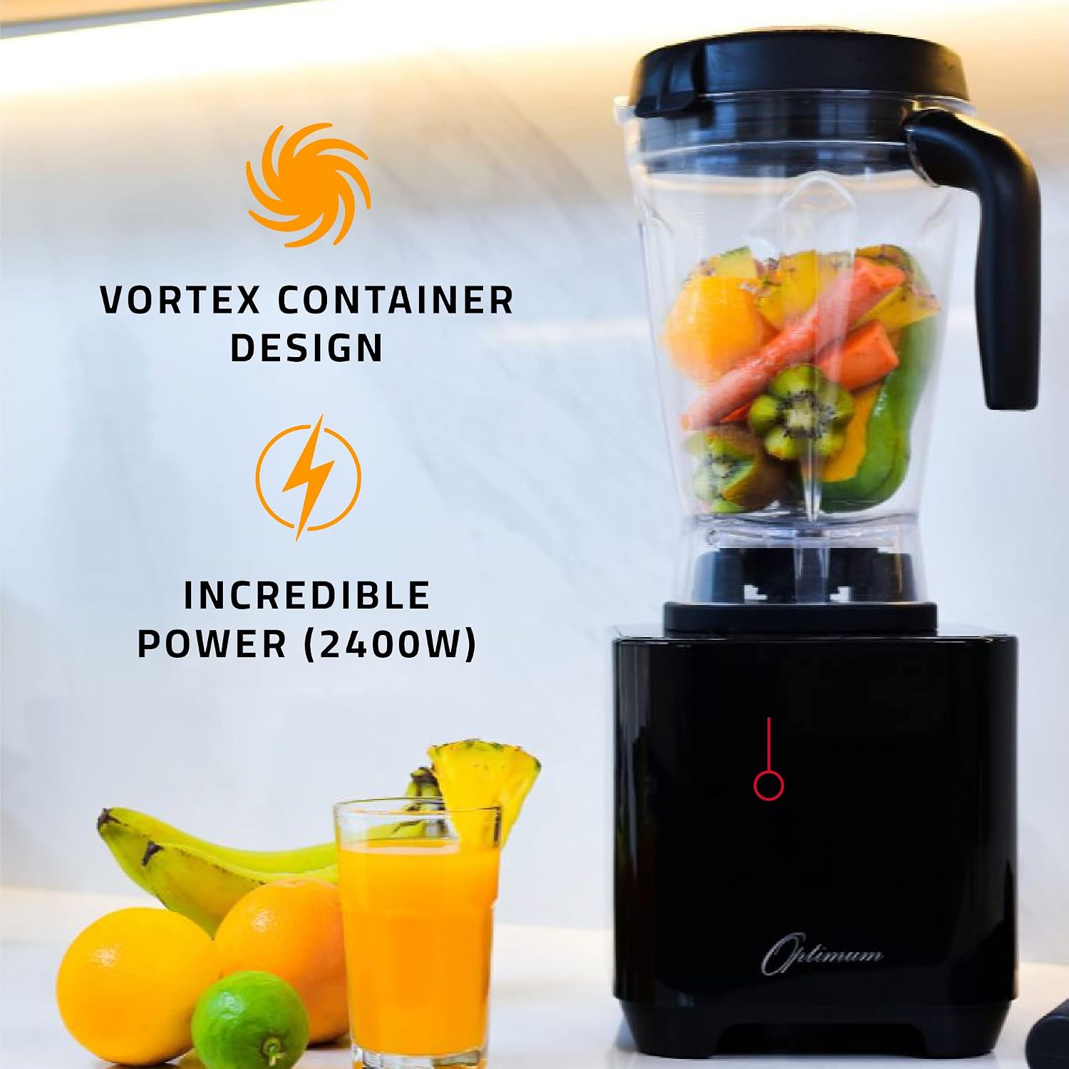 Optimum G2.6 Blender on a kitchen counter with fruits and a glass of orange juice, illustrating its vortex container design and 2400W power.
