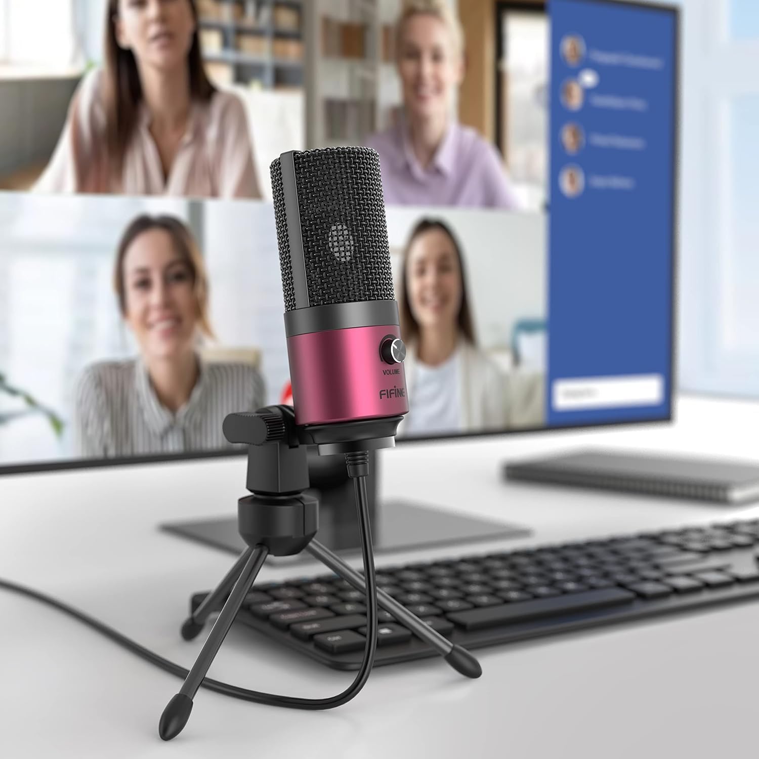 FIFINE K669 microphone set up on a desk with a computer monitor showing a video conference.