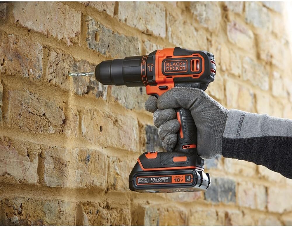 BLACK+DECKER 18V Hammer Drill in use on a brick wall